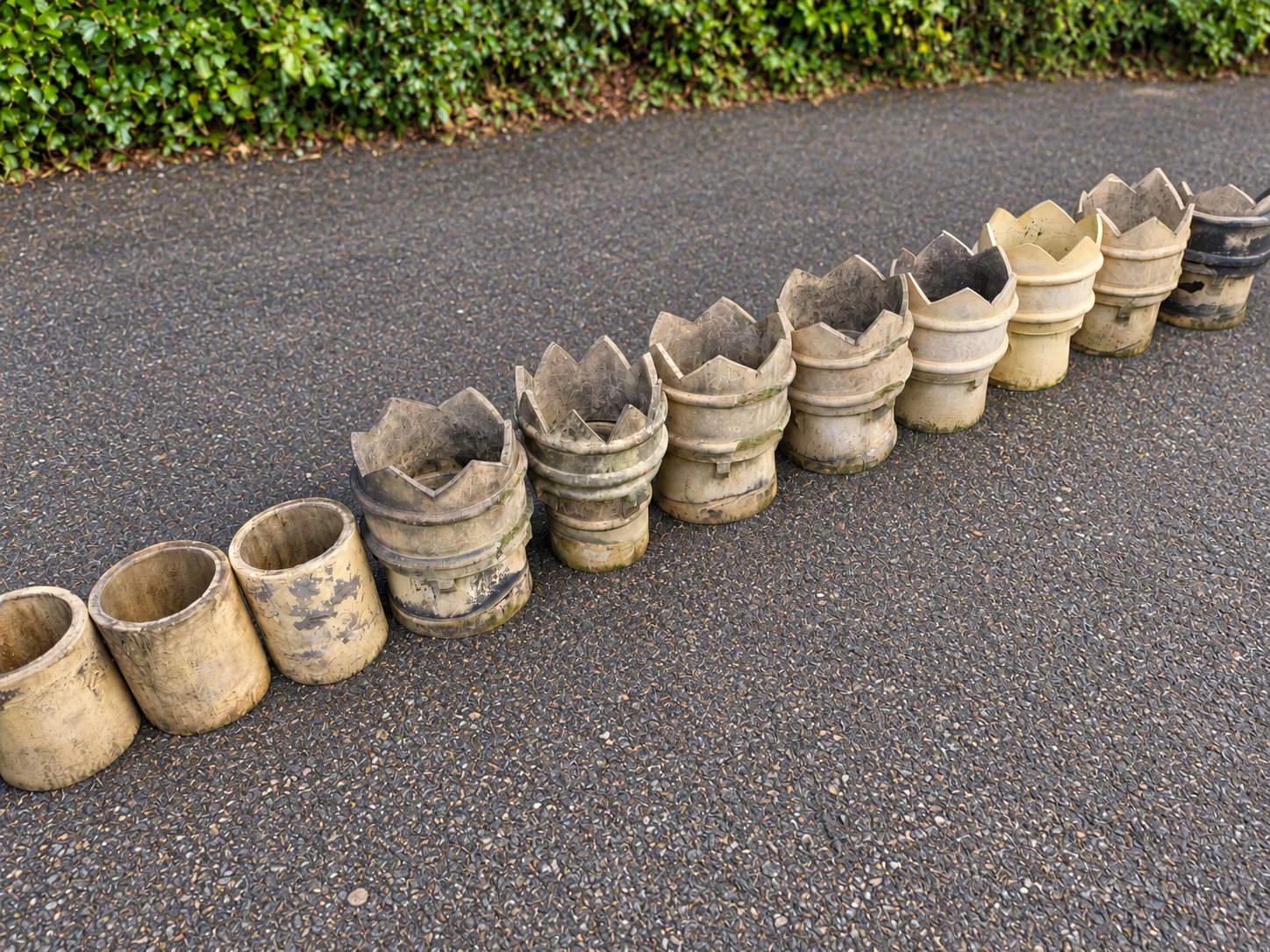 Row of reclaimed chimney pots of different styles